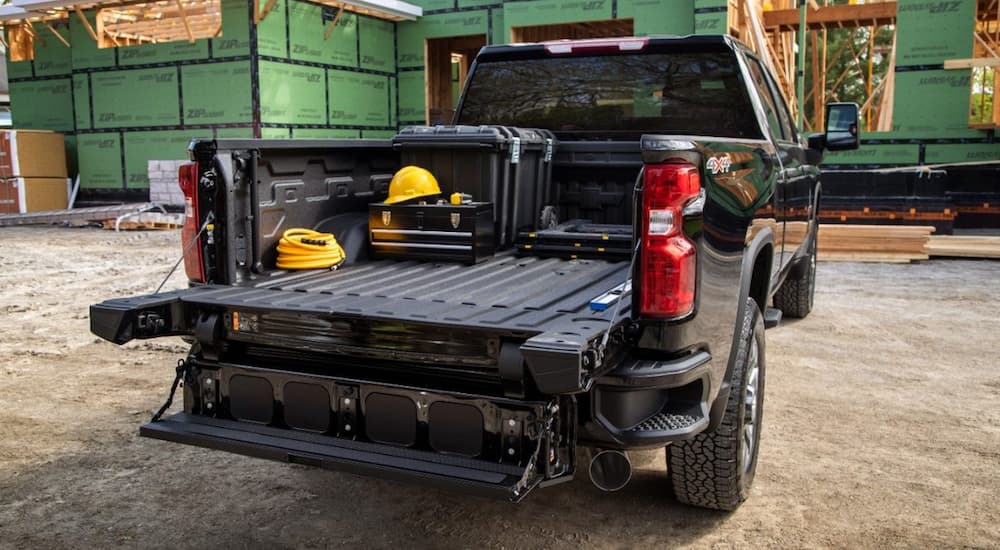 The back of a 2022 Chevy Silverado 1500 HD is shown loaded with tools. 