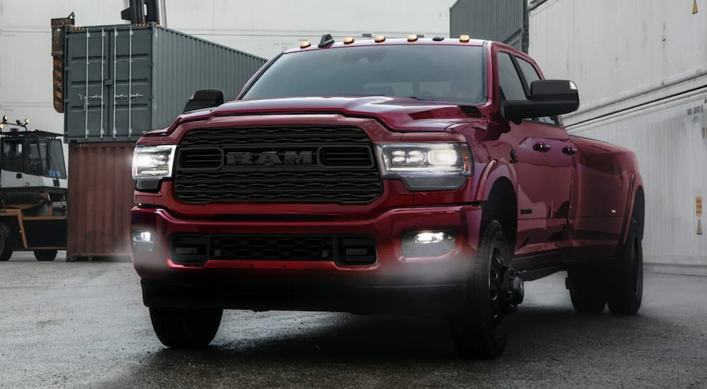 A red 2021 Ram 3500 is shown from the front parked in a foggy loading area.