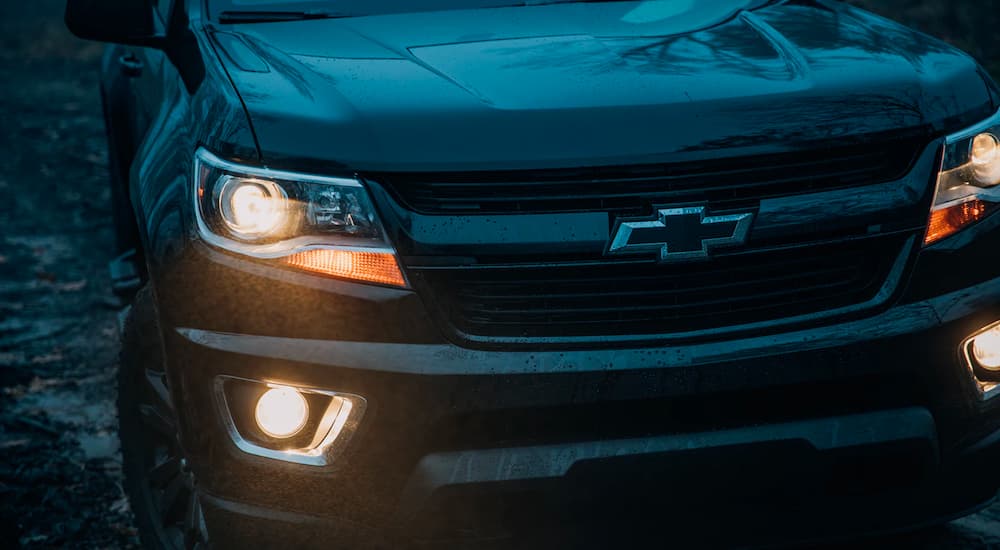 A close up shows the grill and headlights on a black 2018 Chevy Colorado Z71.