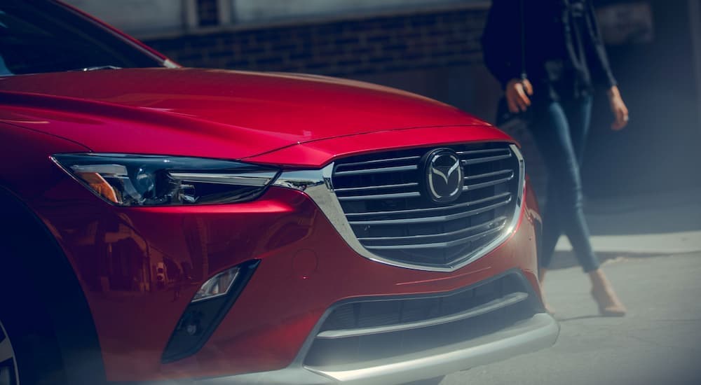 A red 2019 Mazda CX-3 is shown from the front after leaving a used Mazda dealership.