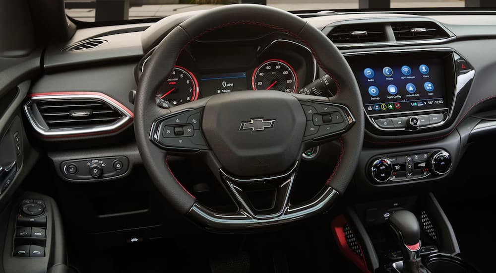 The interior of a 2021 Chevy Trailblazer shows the steering wheel and infotainment screen. 