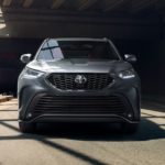 A grey 2021 Toyota Highlander XSE is shown from the front parked partially in shadows.