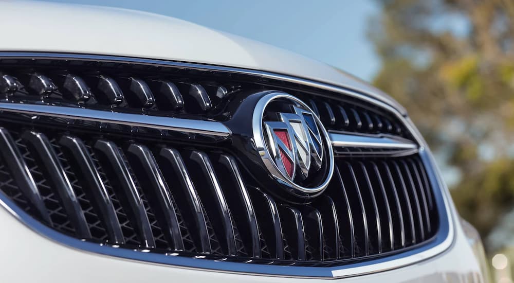 The grille of a 2022 Buick Encore shows the Buick bowtie in closeup.