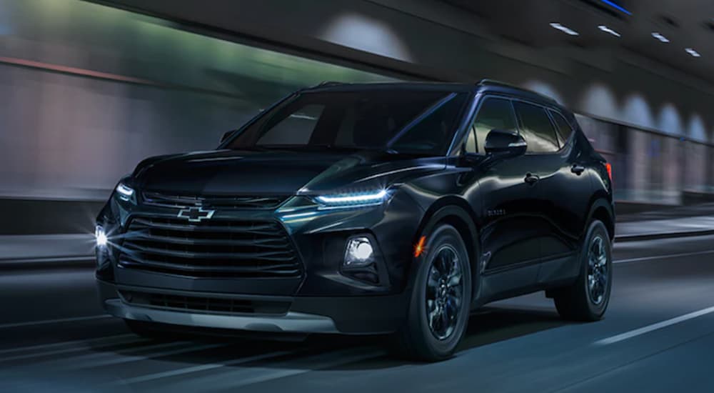 A black 2022 Chevy Blazer is shown driving through a tunnel.