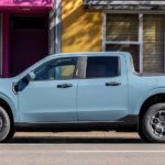 A light blue 2022 Ford Maverick is shown from the side parked on a city street after winning a 2022 Ford Maverick vs 2022 Hyundai Santa Cruz comparison.