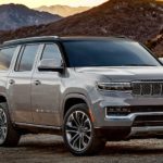 A grey 2022 Grand Wagoneer is shown parked in the mountains after winning a 2022 Grand Wagoneer vs 2021 Cadillac Escalade comparison.