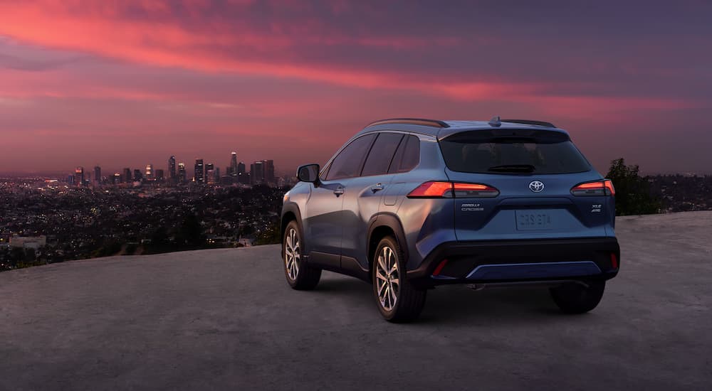 A blue 2022 Toyota Corolla Cross is shown from the rear at sunset.