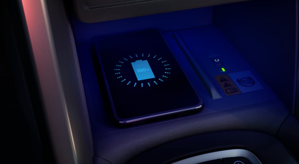 A smart phone is shown charging in a 2022 Toyota Corolla Cross XLE.