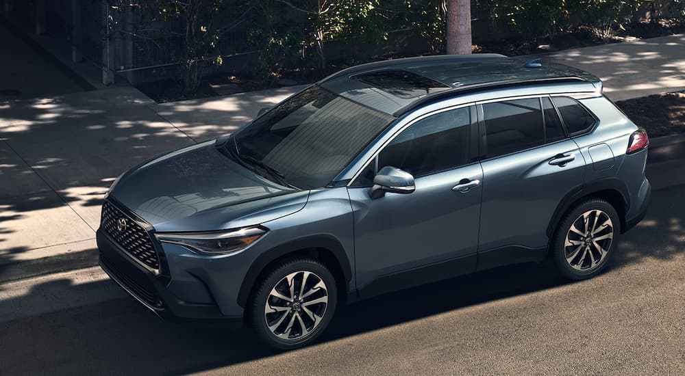 A pale blue 2022 Toyota Corolla Cross XLE is shown from a high angle parked on the street.