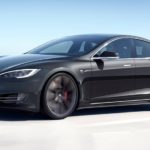 one of the most popular electric vehicles, a black 2021 Tesla Model S, is shown driving down a highway.