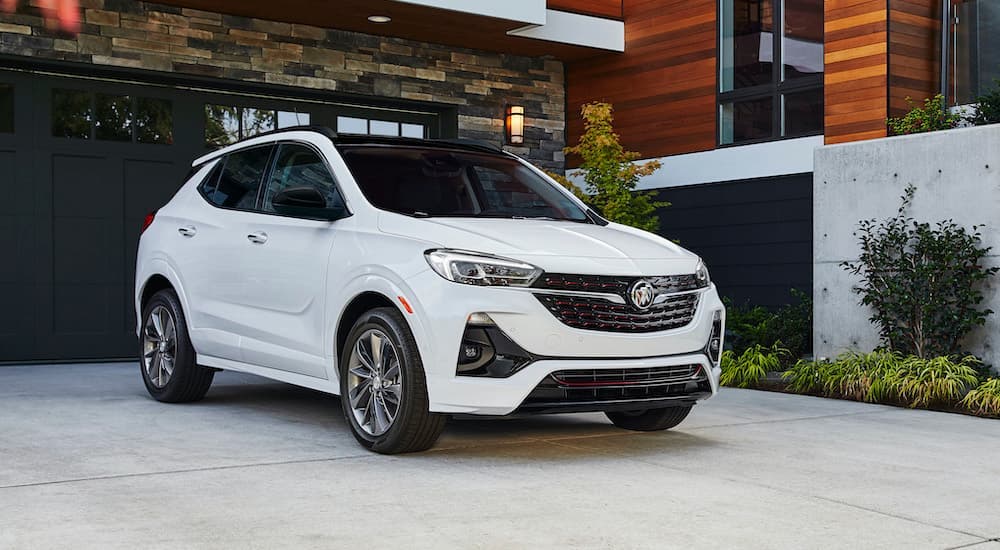 A white 2021 Buick Encore GX ST is shown parked in a modern driveway.