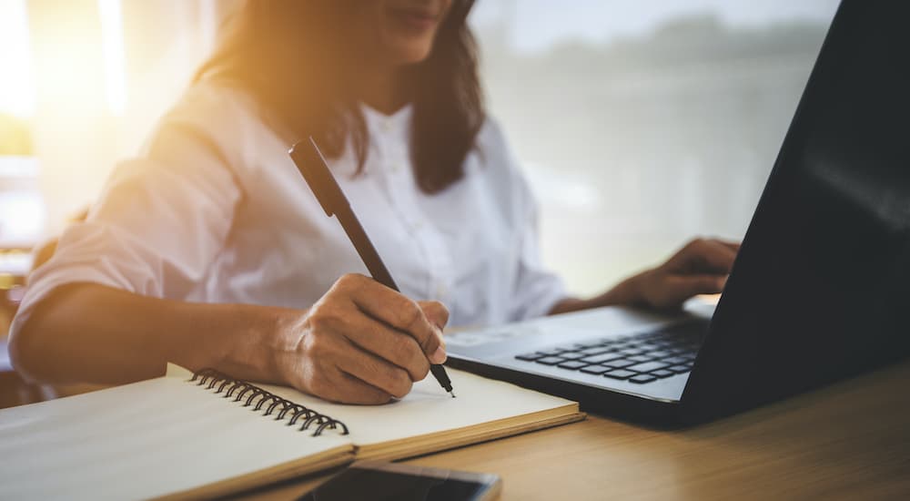 A woman is researching a Nissan Rogue dealership.