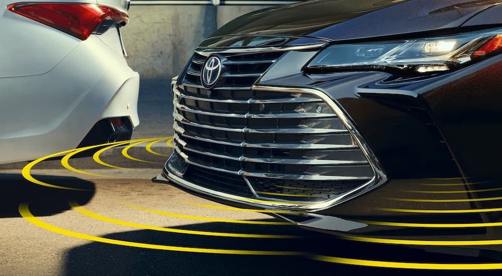 Simulated sensor lines are shown on a black 2021 Toyota Avalon Touring.
