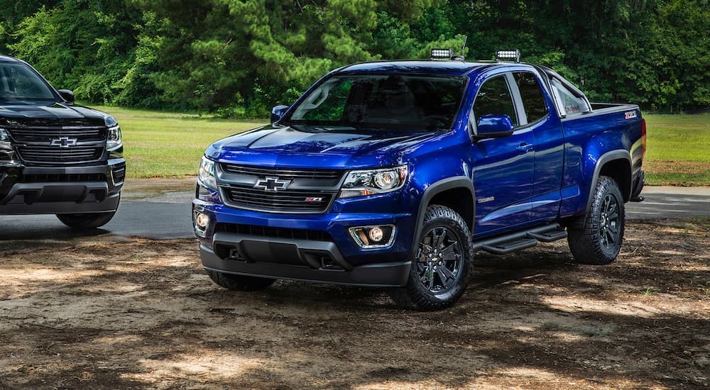 A blue 2016 Chevy Colorado is shown parked in a field after leaving a used Chevy dealer.