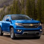 A blue 2020 Chevy Colorado is shown from the front after leaving a used Chevy dealer.