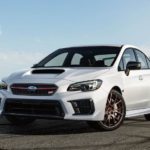 A white 2020 Subaru WRX STI is shown parked on a track after leaving a used car dealer.