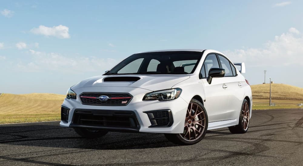 A white 2020 Subaru WRX STI is shown parked on a track after leaving a used car dealer.