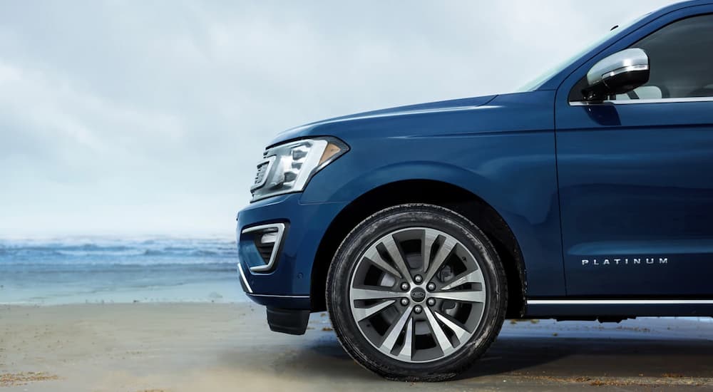A blue 2021 Ford Expedition is shown parked on a beach after winning a 2021 Ford Expedition vs 2021 Nissan Armada comparison.
