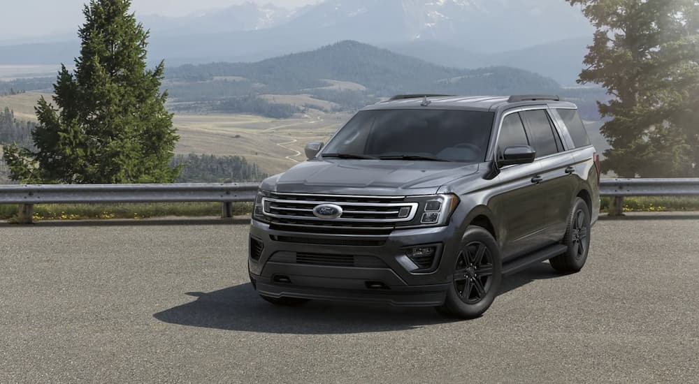 A grey 2021 Ford Expedition is shown from the front parked in front of a mountain.