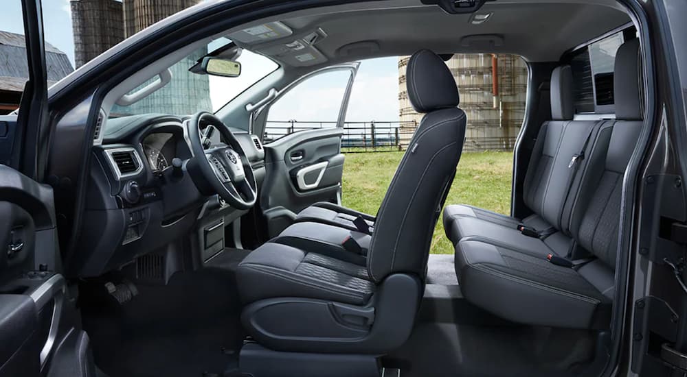 The grey interior of a 2021 Nissan Titan XD shows two rows of seating.