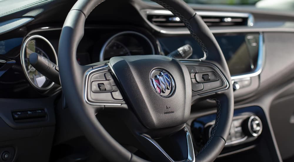 The steering wheel of a 2022 Buick Encore GX is shown in close up.