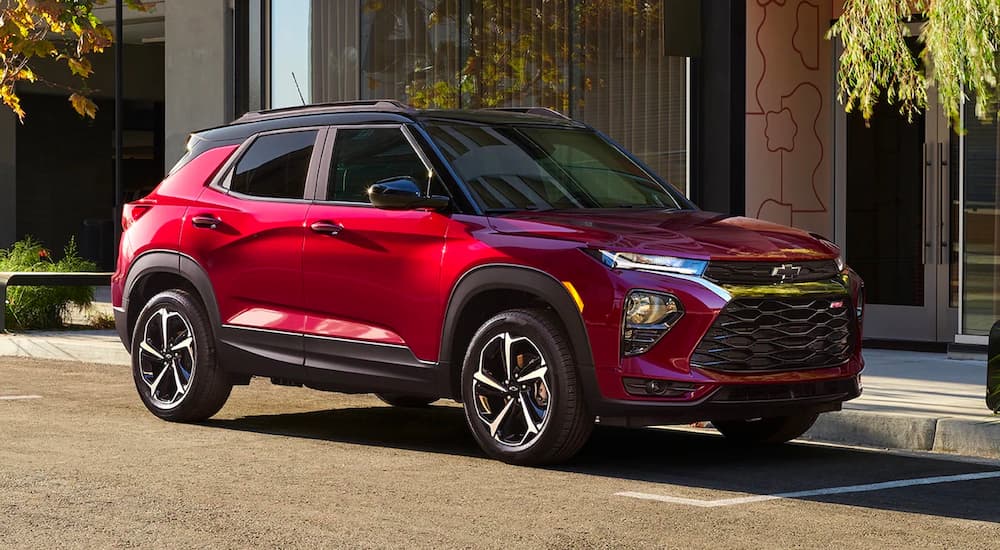 A red 2022 Chevy Trailblazer RS is shown from the side parked on a city street.
