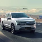 A grey 2022 Ford Lightning is shown from driving on the highway during a 2022 Ford Lightning vs 2022 Tesla Cybertruck comparison.
