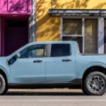 A blue 2022 Ford Maverick is shown from the side parked in a city.