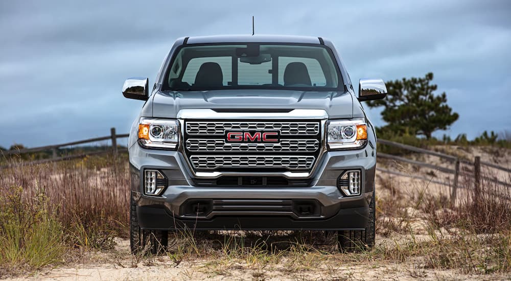 A silver 2022 GMC Canyon Denali is shown from the front parked on a beach.