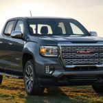 A silver 2022 GMC Canyon Denali is shown parked on a grassy area.