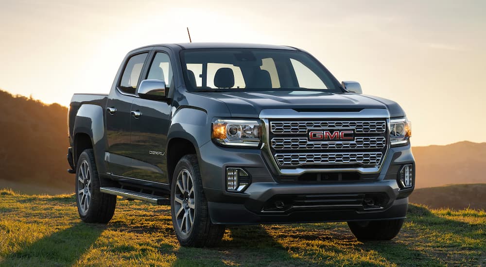 A silver 2022 GMC Canyon Denali is shown parked on a grassy area.