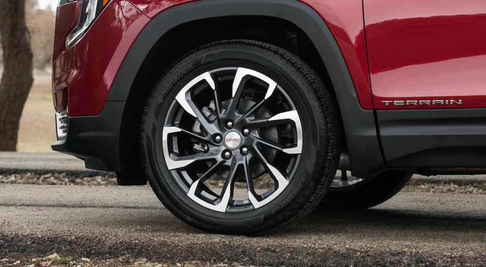 A red 2022 GMC Terrain shows the rear tire in close up.