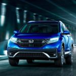 A blue 2022 Honda CR-V Touring is shown from the front driving through a tunnel.