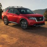 A red 2022 Nissan Pathfinder is shown parked in a remote area for a 2022 Nissan Pathfinder vs 2022 Subaru Ascent comparison.