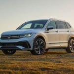 A white 2022 Volkswagen Tiguan S is shown from the side parked in the field.