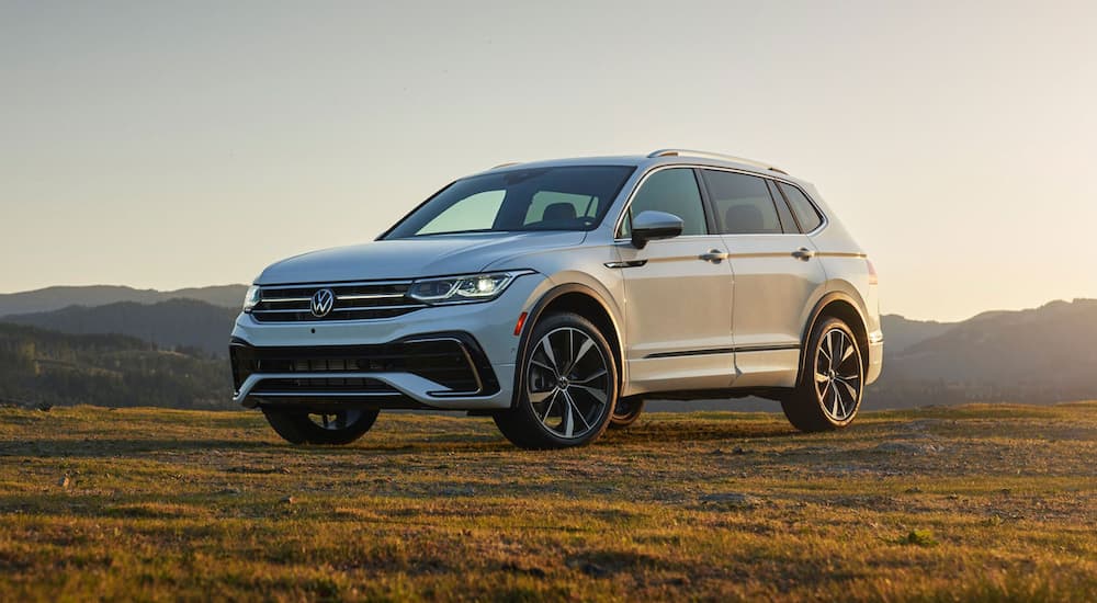 A white 2022 Volkswagen Tiguan S is shown from the side parked in the field.