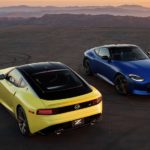 A blue and yellow 2023 Nissan Z are shown from a high angle in an empty parking lot.