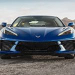A blue 2022 Chevy Corvette Stingray is shown from the front parked on a desert road.