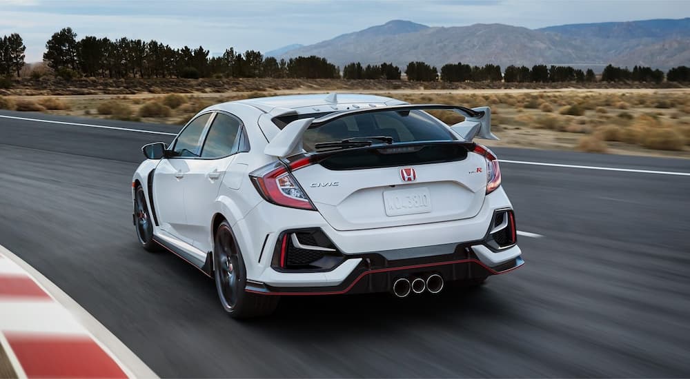 A white 2022 Honda Civic Type R is shown from the rear driving on a track after leaving a Honda Civic dealer.
