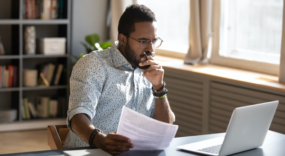 A person is doing research on a laptop.