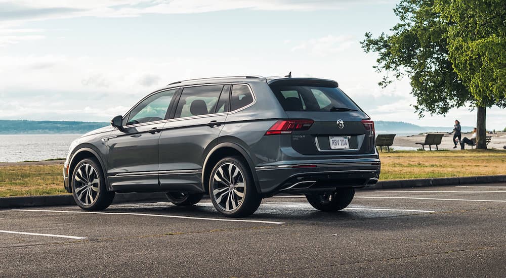 A grey 2021 Volkswagen Tiguan R-Line is shown parked near the ocean.