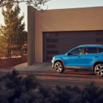 A blue 2022 Volkswagen Taos is shown parked in a driveway.