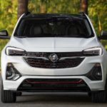 A white 2022 Buick Encore GC is shown from the front parked in front of a forest.