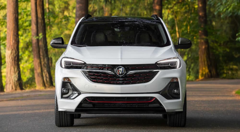 A white 2022 Buick Encore GC is shown from the front parked in front of a forest.