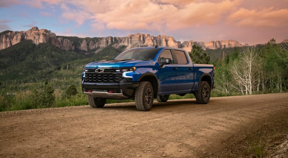 A blue 2022 Chevy Silverado 1500 ZR2 is shown parked on a dirt road.