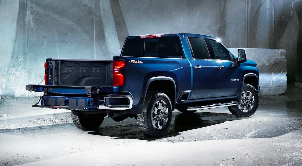 A blue 2022 Chevy Silverado 2500HD is shown from the rear with the tailgate open.