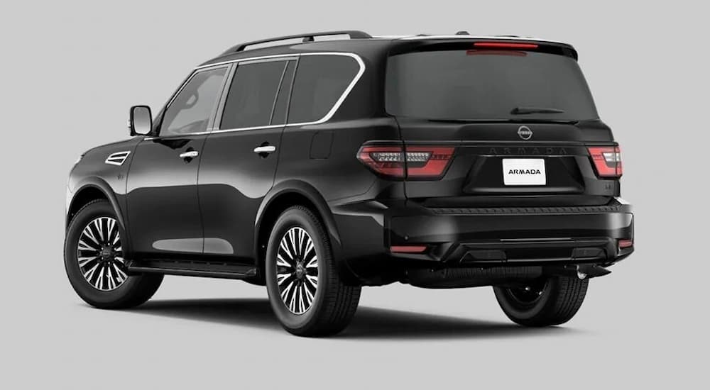 A black 2022 Nissan Armada Midnight Edition is shown from a rear angle on a grey background.