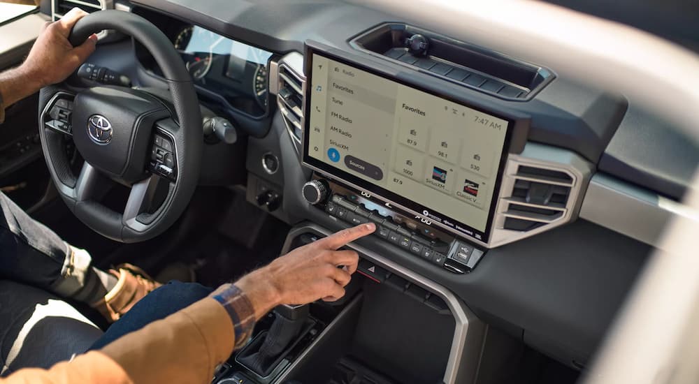 The interior of a 2022 Toyota Tundra shows the steering wheel and infotainment screen.