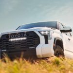 A white 2022 Toyota Tundra Pro is shown parked in a dry grassy field.