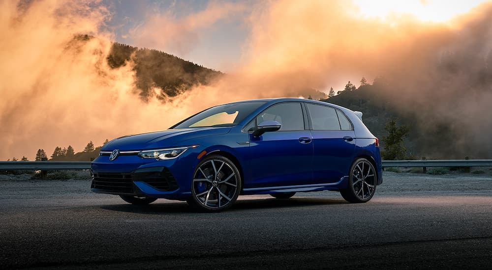 A blue 2022 Volkswagen Golf R is shown parked during a 2022 Volkswagen Golf R vs 2022 Hyundai Veloster N comparison.